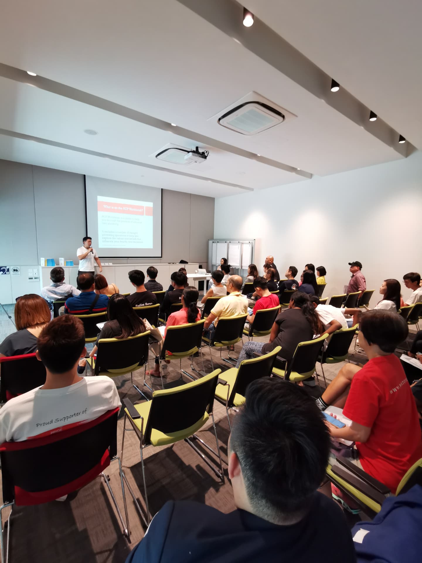 A We Will speaker presenting a planning workshop to a room of parents in Singapore