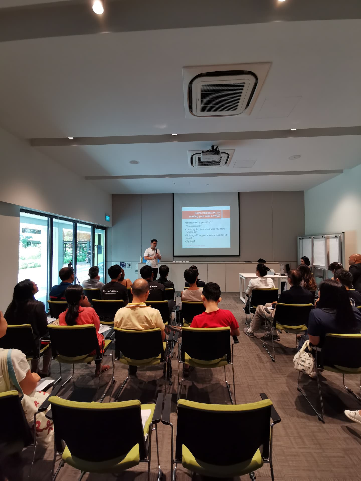 Parents listening to a talk on wills and advance care planning